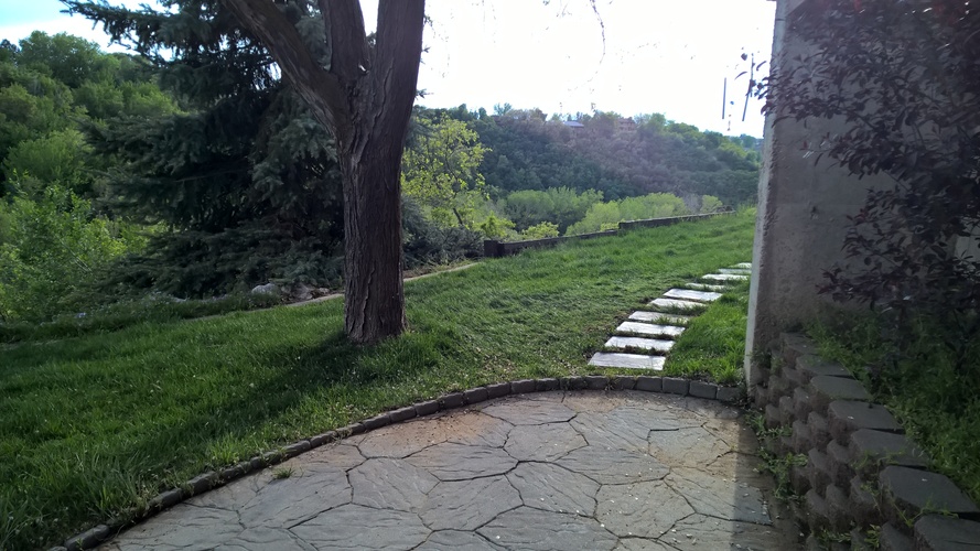 A stone pathway leads through a grassy area.