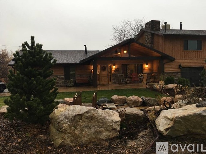 A house with a stone wall in front.