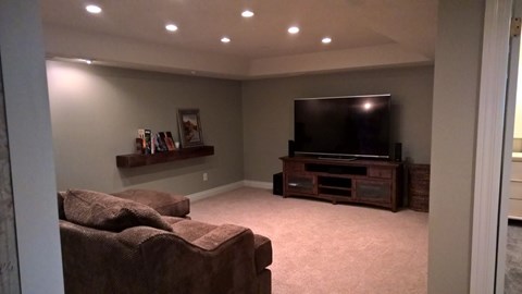 A living room with a couch and a television.