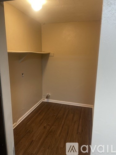 A room with wooden floors and a white wall.