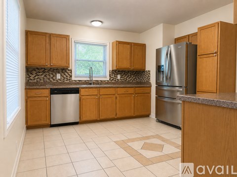 A kitchen with wooden cabinets and a granite countertop.
