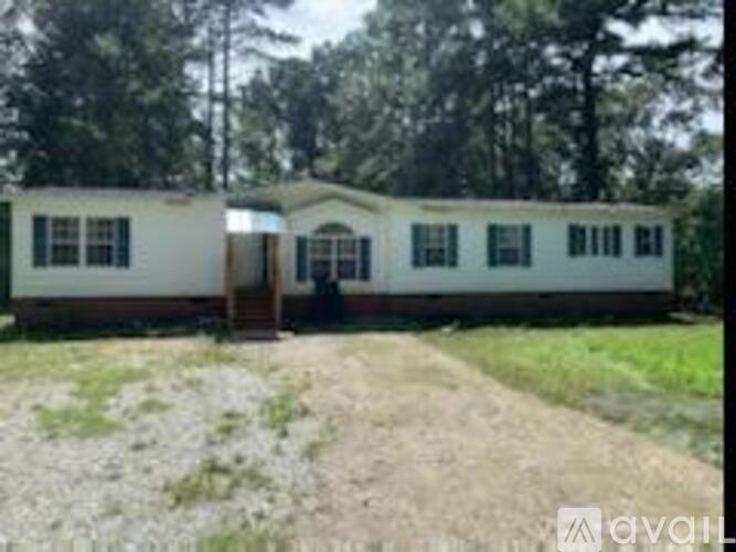 A white mobile home with a brown door and windows.