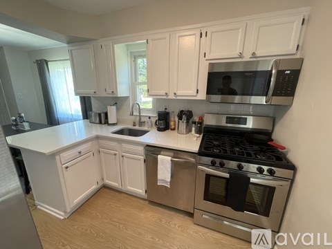 A kitchen with white cabinets and stainless steel appliances.