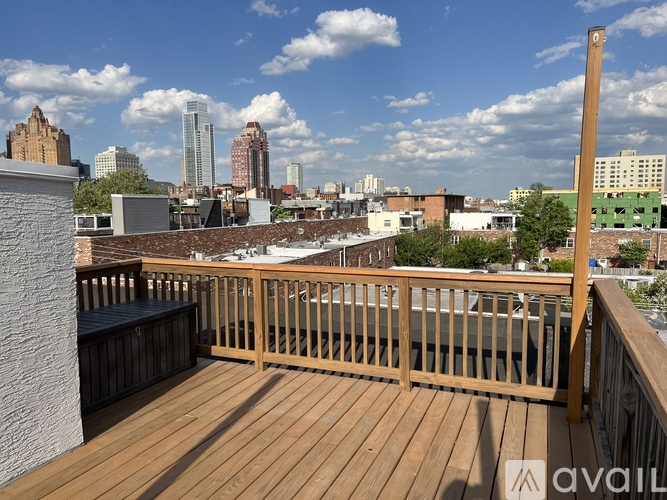 A wooden deck overlooks a city skyline.