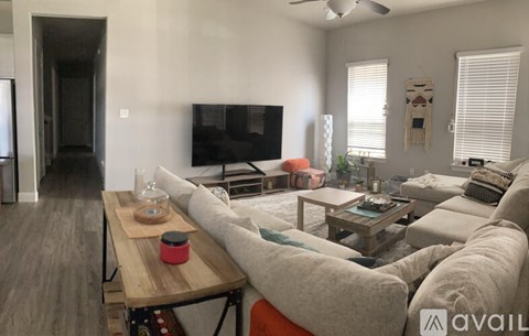 A living room with a grey couch and a wooden coffee table.