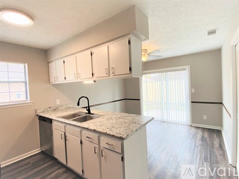 A kitchen with a sink and cabinets.