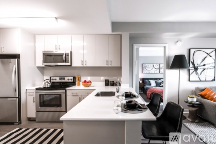 A modern kitchen with a dining table and chairs.
