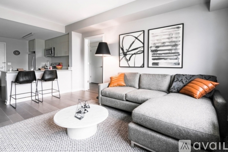 A living room with a grey couch and a white coffee table.