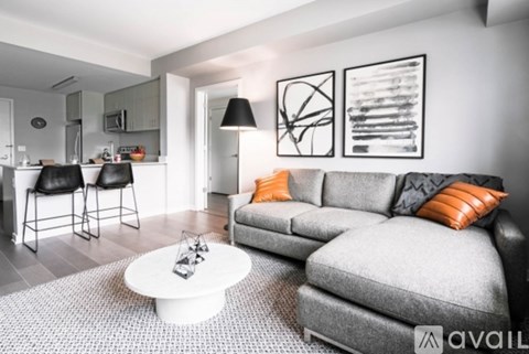 A living room with a grey couch and a white coffee table.