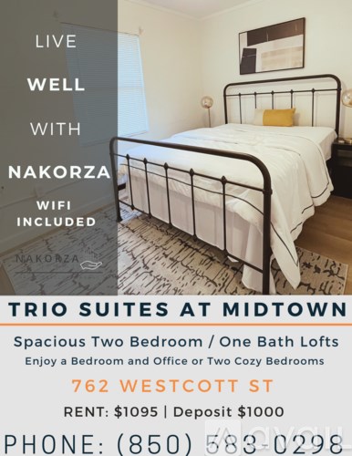 A bedroom with a bed, nightstand, and lamp advertising Nakorza wifi.