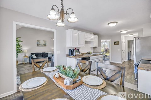 A modern kitchen with a dining table set for two.
