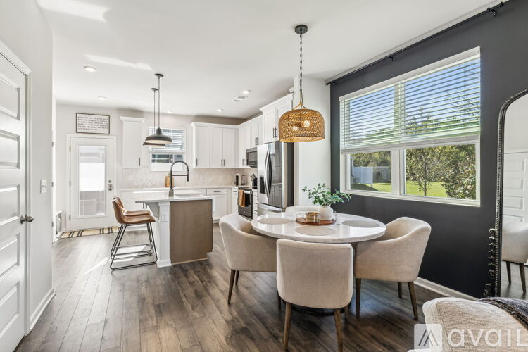A modern kitchen with a dining table set for four.