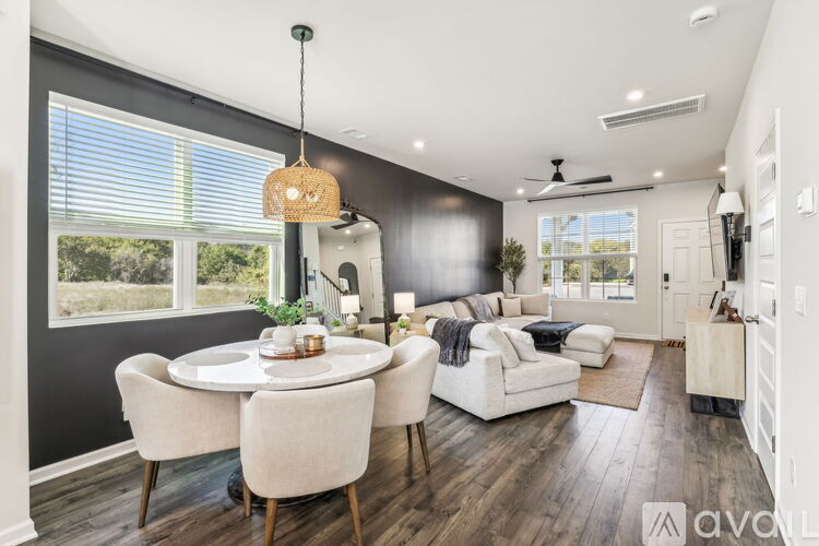 A modern dining room with a round table and chairs.