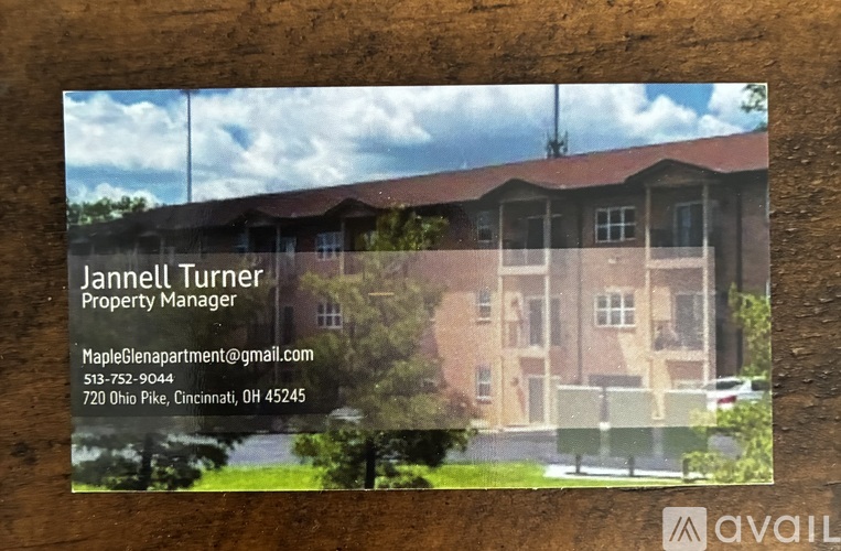 A business card for Jannett Turner, Property Manager, with a background image of a building.