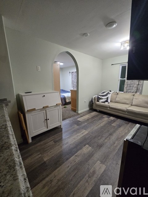 A living room with a couch and a cabinet.
