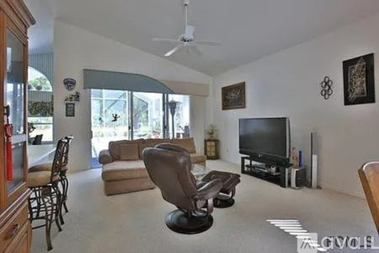 A living room with a television and a chair.