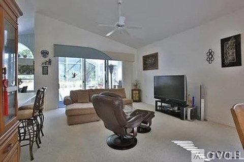 A living room with a television and a chair.