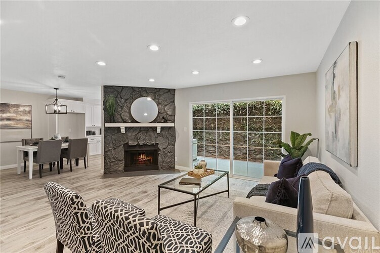A living room with a fireplace and a glass table.