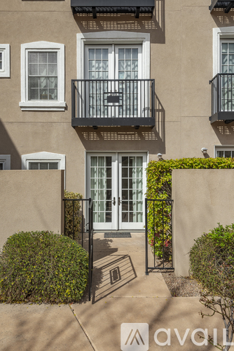 A building with a balcony and a door is shown.