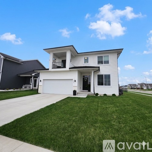 A two-story house with a garage is shown in the image.