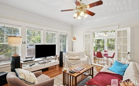 A living room with a brown chair and a white couch.