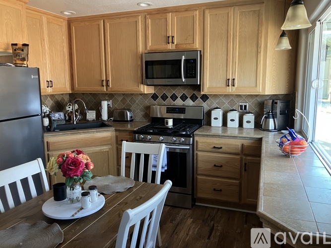 A kitchen with wooden cabinets and a black stove top oven.