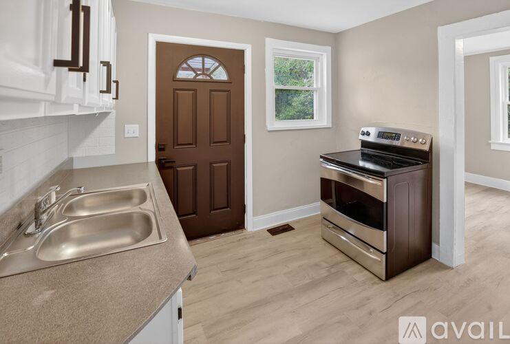 A kitchen with a sink, stove, and oven.
