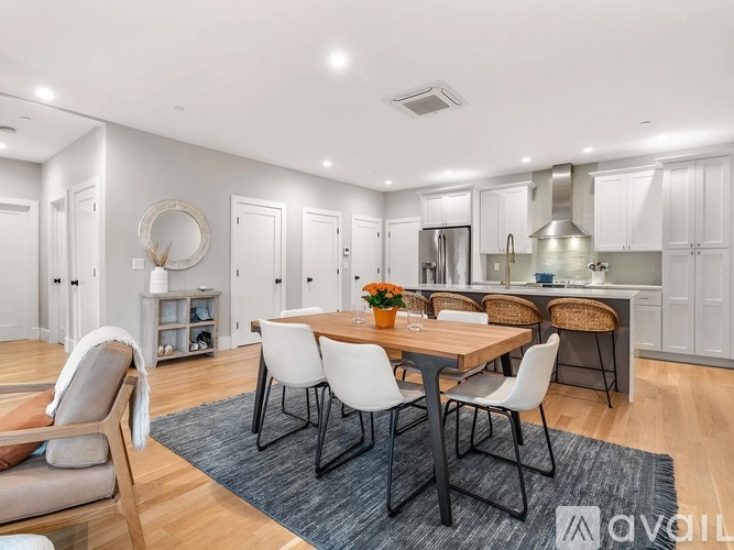 A modern dining room with a wooden table and chairs.