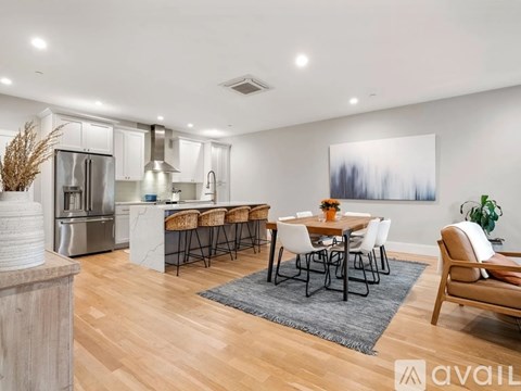 A modern kitchen with a dining table set for six.