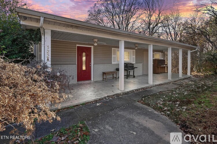 A house with a red door is for sale.