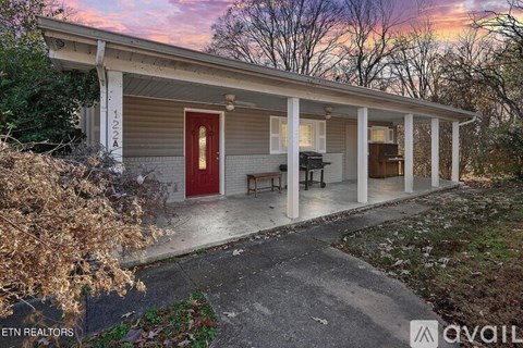 A house with a red door is for sale.