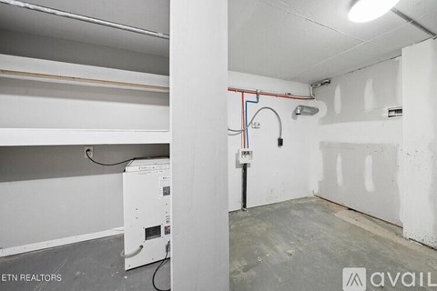 A white wall with a red and blue pipe running through it.