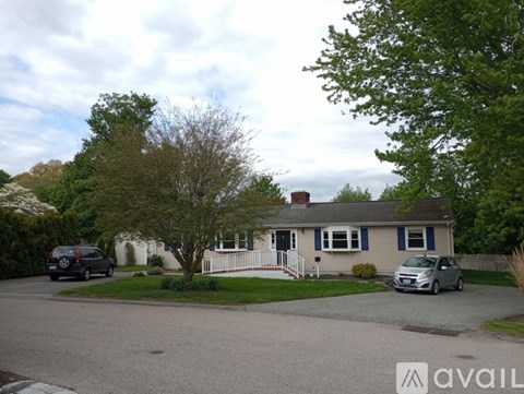 A house with a car parked in front of it.