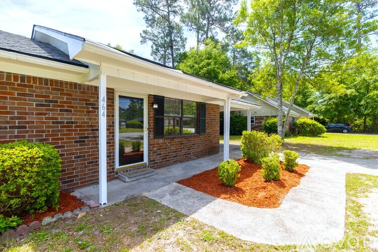 A house with a red brick exterior and a white roof.