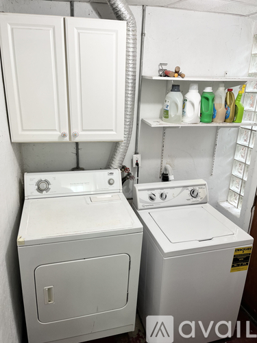 A white washing machine and dryer in a small laundry room.