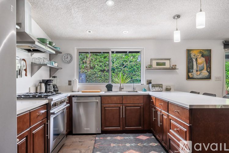 A kitchen with wooden cabinets and stainless steel appliances.