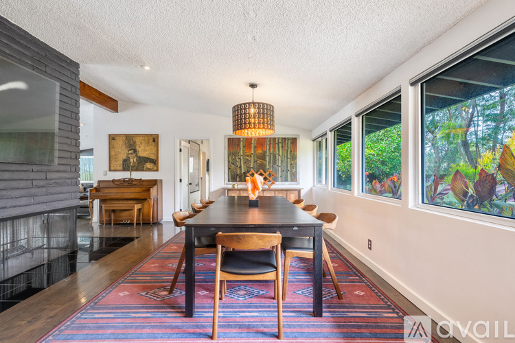 A dining room with a long table and chairs.