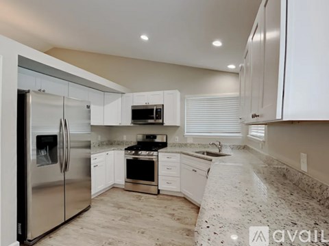 A kitchen with granite countertops and stainless steel appliances.