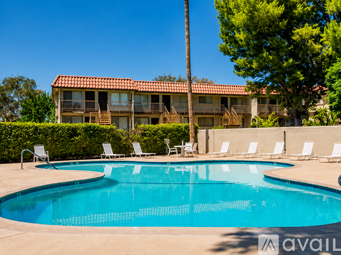 A large house with a pool in front.