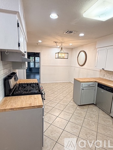 A kitchen with a stove top oven and a dishwasher.