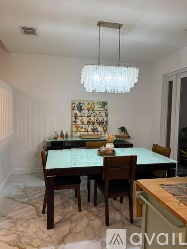 A dining room with a table set for six people.