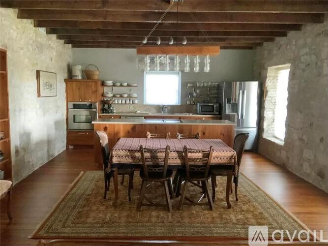 A dining room with a table set for six.