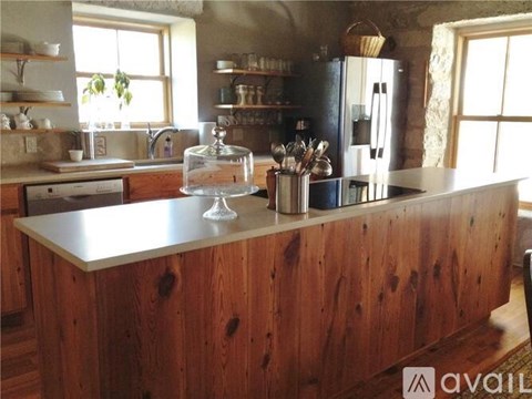 A kitchen with wooden cabinets and a large island.