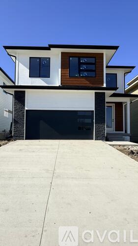 A modern house with a black garage door.