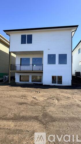 A two-story house with a balcony is for sale.