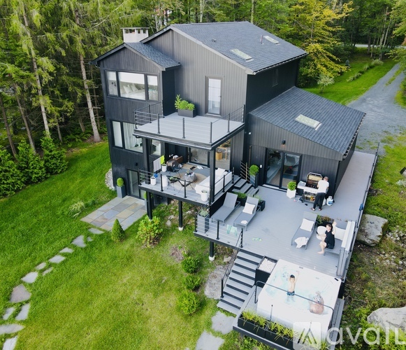 A modern house with a balcony and a garden.