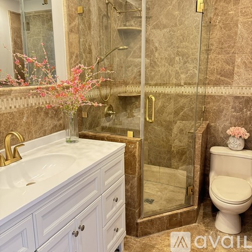 A bathroom with a sink, toilet, and shower.