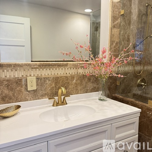 A bathroom with a white sink and a mirror above it.