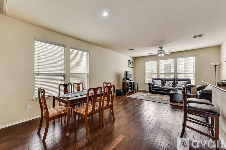 A dining room with a table set for six.