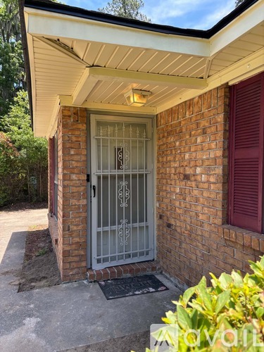 A small house with a red window and a glass door.